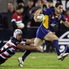 Otago winger Karne Hesketh breaks the tackle of Counties-Manukau flanker Fritz Lee at Mt Smart...