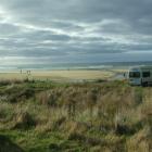 Tourists and surfers alike are drawn to Purakaunui Bay in the Catlins. Photo by Helena de Reus.