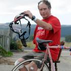 Outram cyclist John Nicholl with the remains of his bicycle and helmet yesterday after he was hit...