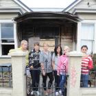 Outside their fire-damaged flat are University of Otago students (from left) Phoebe Roche (22),...