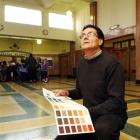 Contract conservator Laurence Le Ber holds a colour chart and reflects on the more sombre colours...