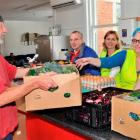 Pact members (from left) Ross Chirnside and Graeme Russell help FoodShare CEO Deborah Manning and...