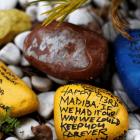 Painted stones with messages wishing Nelson Mandela a happy birthday are seen outside his house...