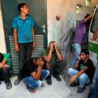 Palestinians mourn outside al-Aqsa hospital in Deir al-Balah in central Gaza Strip after an...