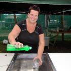 Pam Anderson, of Oamaru, tries out the twin-rinse litchen sink at the Te Akatarawa camp site....