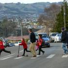 Parents and children use a pedestrian crossing near Brockville School yesterday.  The site will...