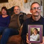 Parents Helen and Jim Christie are supporting their son-in-law Andy Ball, who holds a picture of...