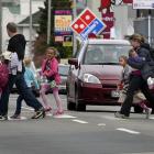 Parents picking up their children after school use a Great King St pedestrian crossing which will...