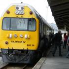 Passengers disembark from the Taieri Gorge Railway's Silver Fern railcar at Oamaru Railway...
