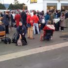 Passengers outside Dunedin Airport after they were evacuated this morning. Photo by Craig Baxter
