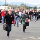 Passengers rush towards the Dunedin International Airport terminal when it was reopened after a...