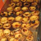 Pasteis de nata (Portuguese custard tarts) are piled high in a local bakery. Photo by Pam Jones.