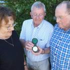 Pat Paulin (centre), of Frankton, shows a barometer to Hugh and Viv Beilby, of Auckland, that was...