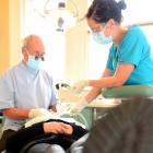 Patient Pania Teau is attended to  by dentist Steve Duncan and dental assistant Kim Spooner....