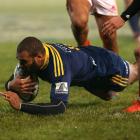 Patrick Osborne of the Highlanders dives over to score a try during the round 16 Super Rugby...