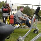 Paul Barron looks over his gyrocopter, one of seven which fly out of Taieri Airfield. Photo by...