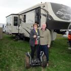 Pauline and Les Johnson with one of their  Segways outside their Big Country fifth-wheeler...