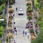 Pedestrians and vehicles in a busy Baldwin St, Dunedin, yesterday.