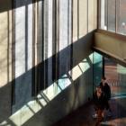 Pedestrians in the University of Otago Richardson Building walk past a colour reproduction of...