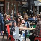 People enjoy summer weather in Dunedin’s lower Octagon yesterday. Photo by Christine O'Connor.