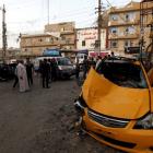 People gather at the site of a car bomb attack in Baghdad at the weekend. REUTERS/Thaier Al-Sudani