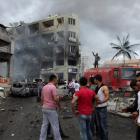 People gather at the site of an explosion in the town of Reyhanli near the Turkish-Syrian border....