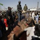 People in Karachi, Pakistan, surround a carcass of a whale shark that was found dead in the...