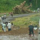 People  make their way along a damaged road near Ba.