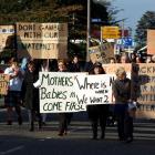 People march through the main street of Tuatapere yesterday morning, calling for the town's...