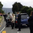 People waiting to pick up incoming passengers on the Wellington flight line up at the police...