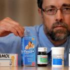 Pharmacologist Associate Prof David Reith displays some medication labelling on which the brand...