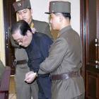 Jang Song-thaek, with his hands bound, is dragged into the court by uniformed personnel last week...