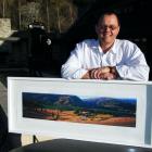 Photographer Allan Johnston and his large-format film camera with one of his works, Felton Road A...