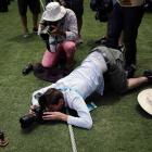 Photographers take pictures of a replica Ashes urn on the Gabba field on Wednesday, the day...