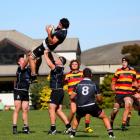 Pirates lock Andrew Johnson takes a kick-off as he is supported by Clinton Garrity (left) and...