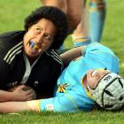 Pirates prop Gemma Tuhega shows her pleasure at scoring in the tackle of University lock Julia...