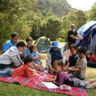 Playing cards at the Trotters Gorge Doc camp site are the Newton family (clockwise, from front...