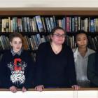 Poetry Slam competitors listen to a poem in the library last night. Photos by Peter McIntosh.