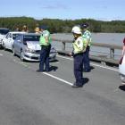 Police and emergency services attend a nose-to-tail crash involving four vehicles, from the white...
