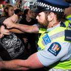 Police and security clash with protesters outside SkyCity during the post-Budget address. Photo...