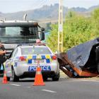 Police at the scene where a tractor rolled down a bank onto SH2, Te Hauke, South of Hastings,...
