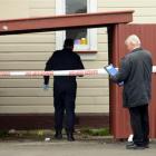 Police examine the scene of an alleged sexual assault at a South Dunedin property yesterday...