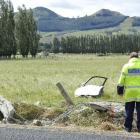 Police examine the scene of the Bush Rd, Mosgiel, crash. Photo by Gerard O'Brien..