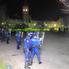 Police face off with students on the University of Otago campus early yesterday. Photo by Craig...