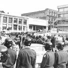 Police hold the line near the rear bus entrance to the Southern Cross Hotel in Dunedin during the...