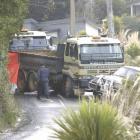 Police inspect the scene of a collision between two heavy earthmoving trucks on Luss Rd, Company...