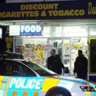 Police make inquiries at the Melbourne Dairy in South Dunedin after it was on Saturday night....