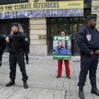 Police secure the area as Greenpeace activists protest in front of Gazprom headquarters in Paris....