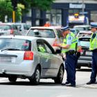 Police talk to a driver during an operation in Crawford St, Dunedin, yesterday. Photo by Linda...
