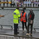 Police talk to protesters at Back Beach yesterday.